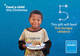 Virtual charity Christmas gift card design featuring smiling young boy holding a plate of food against a blue starry background with text reading 'Feed a child this Christmas'. A Mary's Meals logo appears in the lower right.